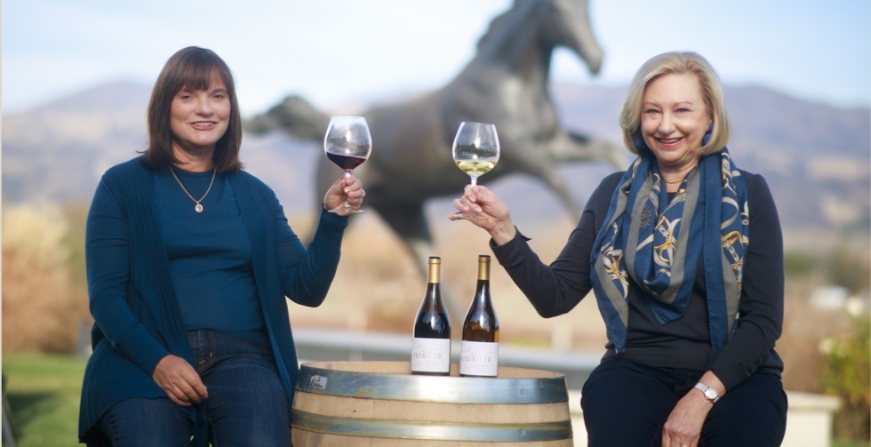 two women drinking wine